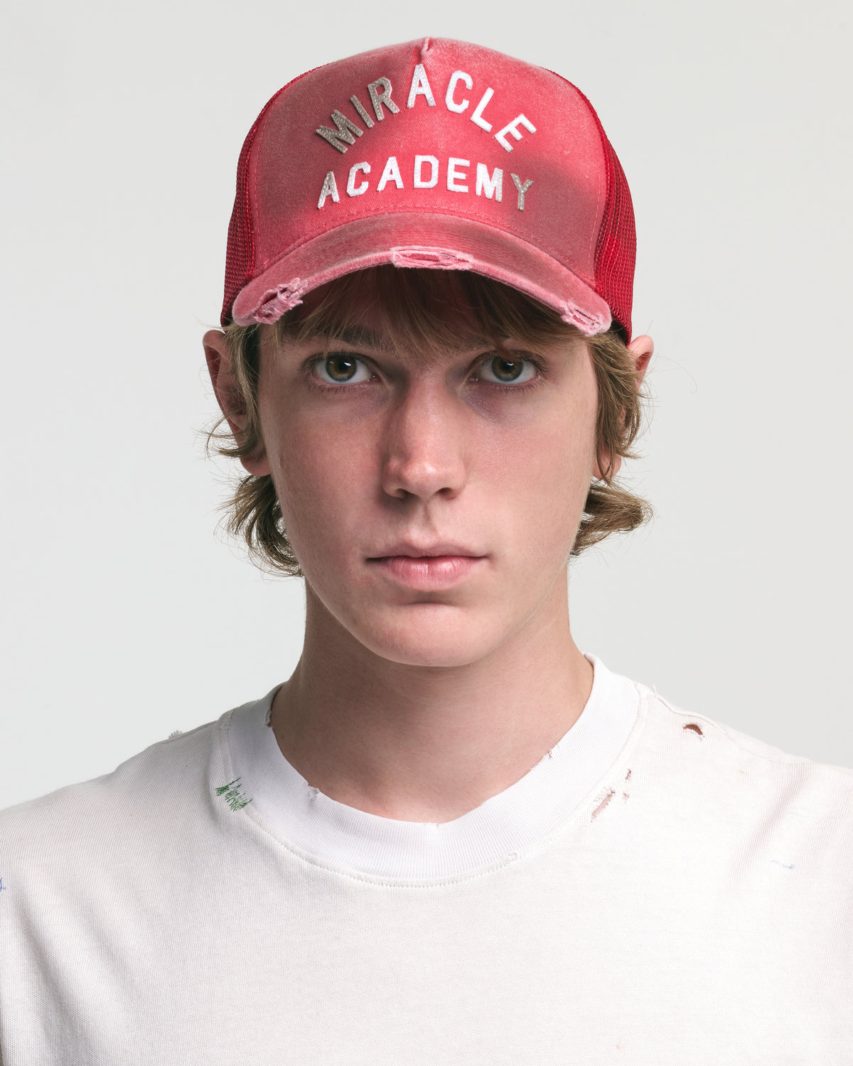 DISTRESSED MIRACLE ACADEMY TRUCKER HAT