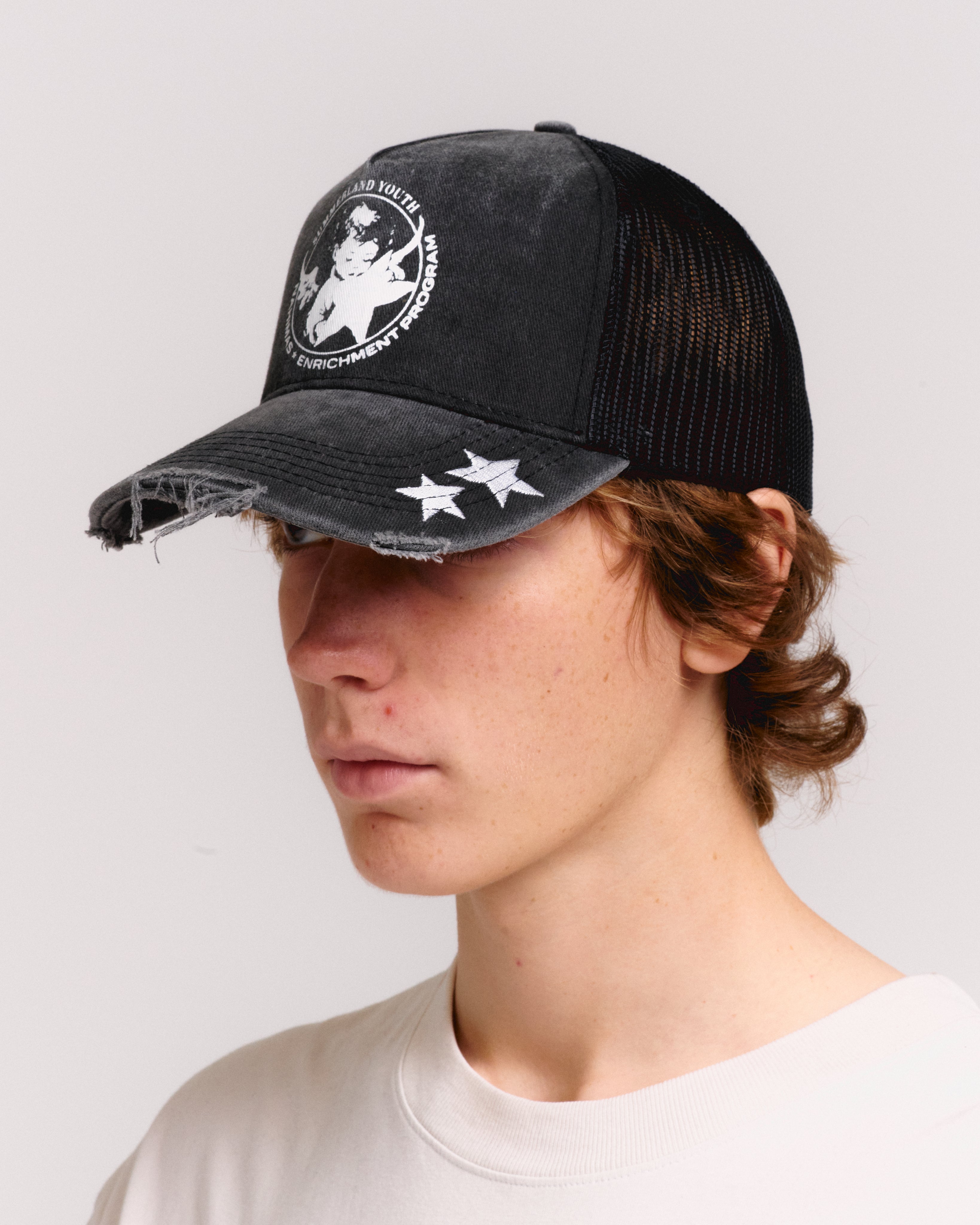 YOUTH ENRICHMENT WASHED TRUCKER HAT – NAHMIAS