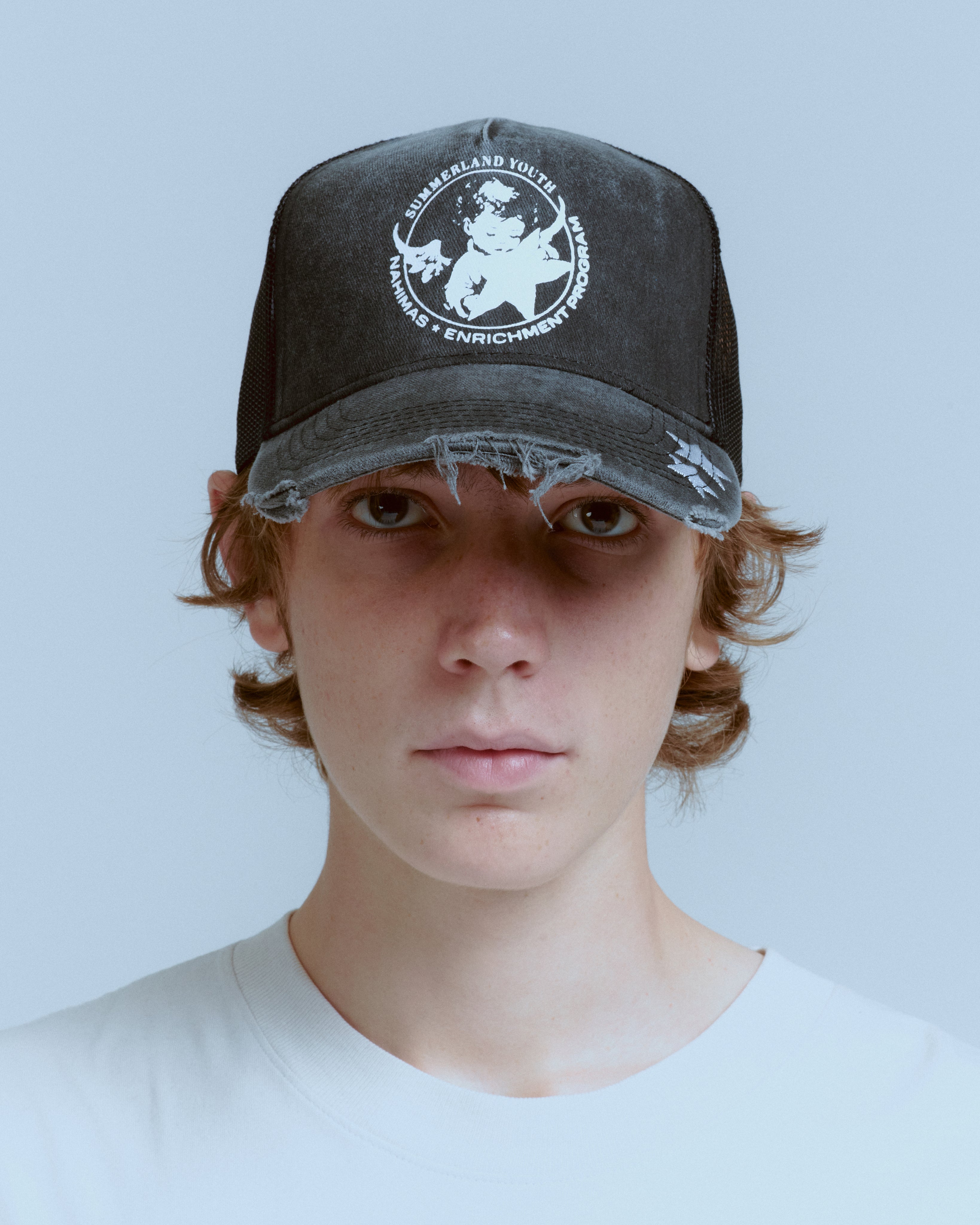 YOUTH ENRICHMENT WASHED TRUCKER HAT – NAHMIAS