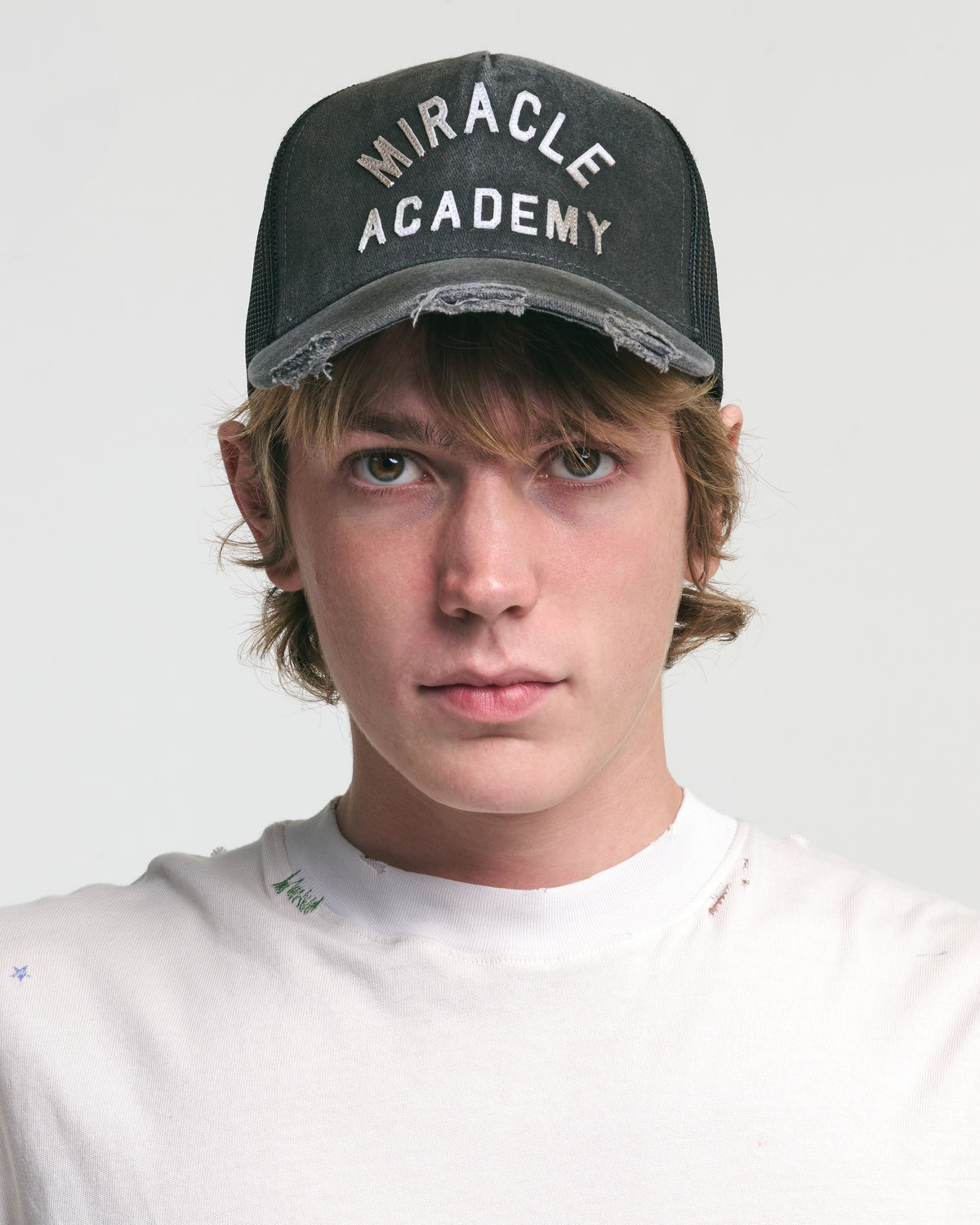 DISTRESSED MIRACLE ACADEMY TRUCKER HAT