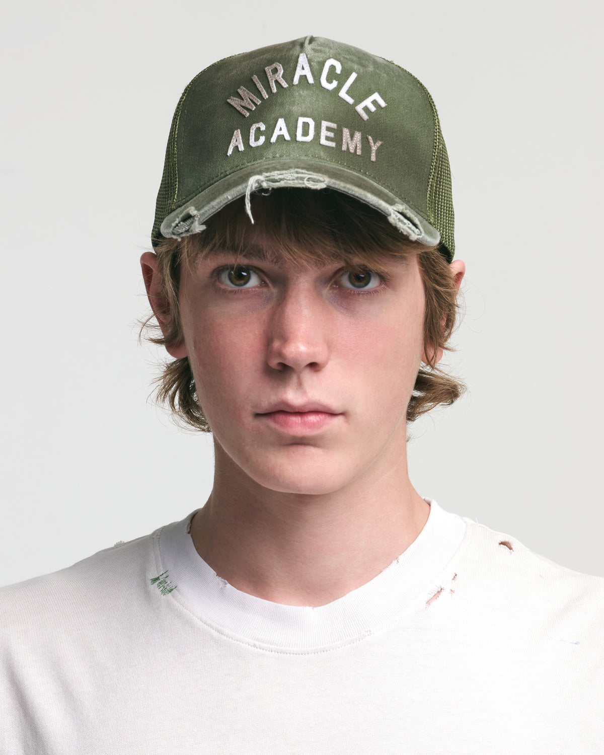 DISTRESSED MIRACLE ACADEMY TRUCKER HAT